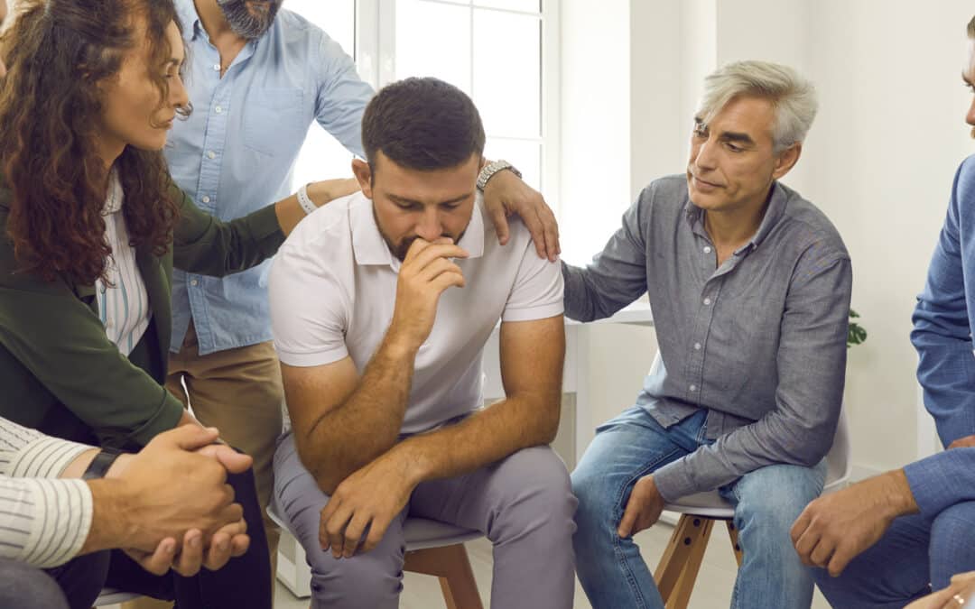 group comforting man