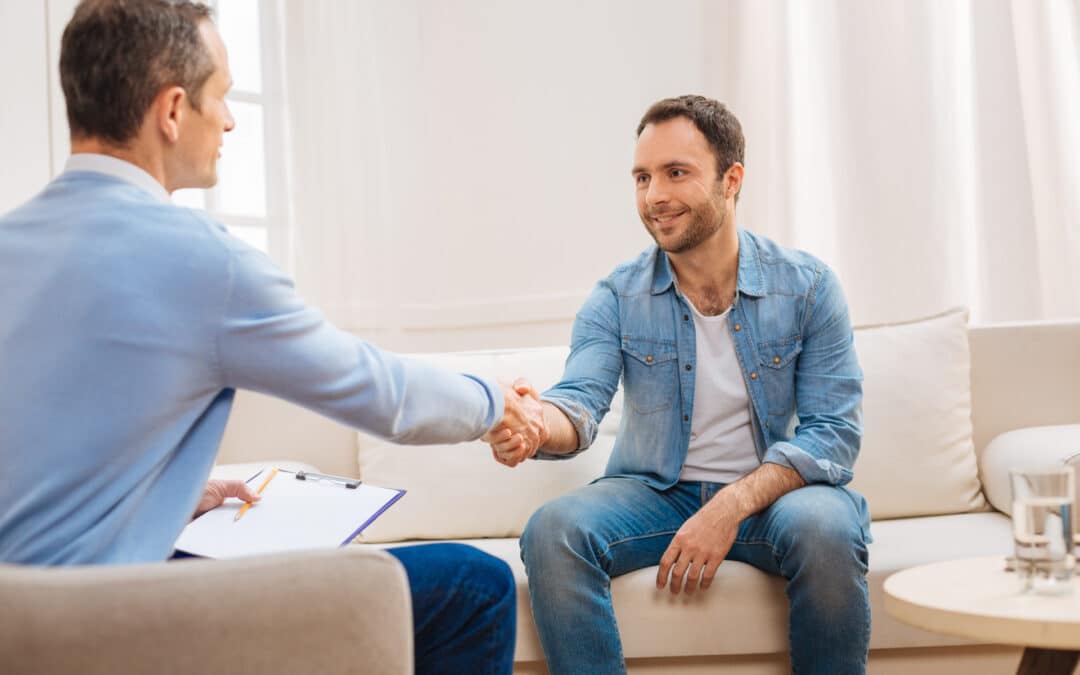 Man in sobriety shaking employers hand